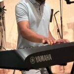 Christopher, miembro de la juventud y talentoso tecladista, toca el teclado durante el servicio con enfoque y pasión, liderando la alabanza con su música.