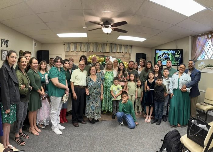 Church members gathered at the front of Iglesia Vision Sinai Church, symbolizing unity, faith, and a welcoming community where no one walks alone.